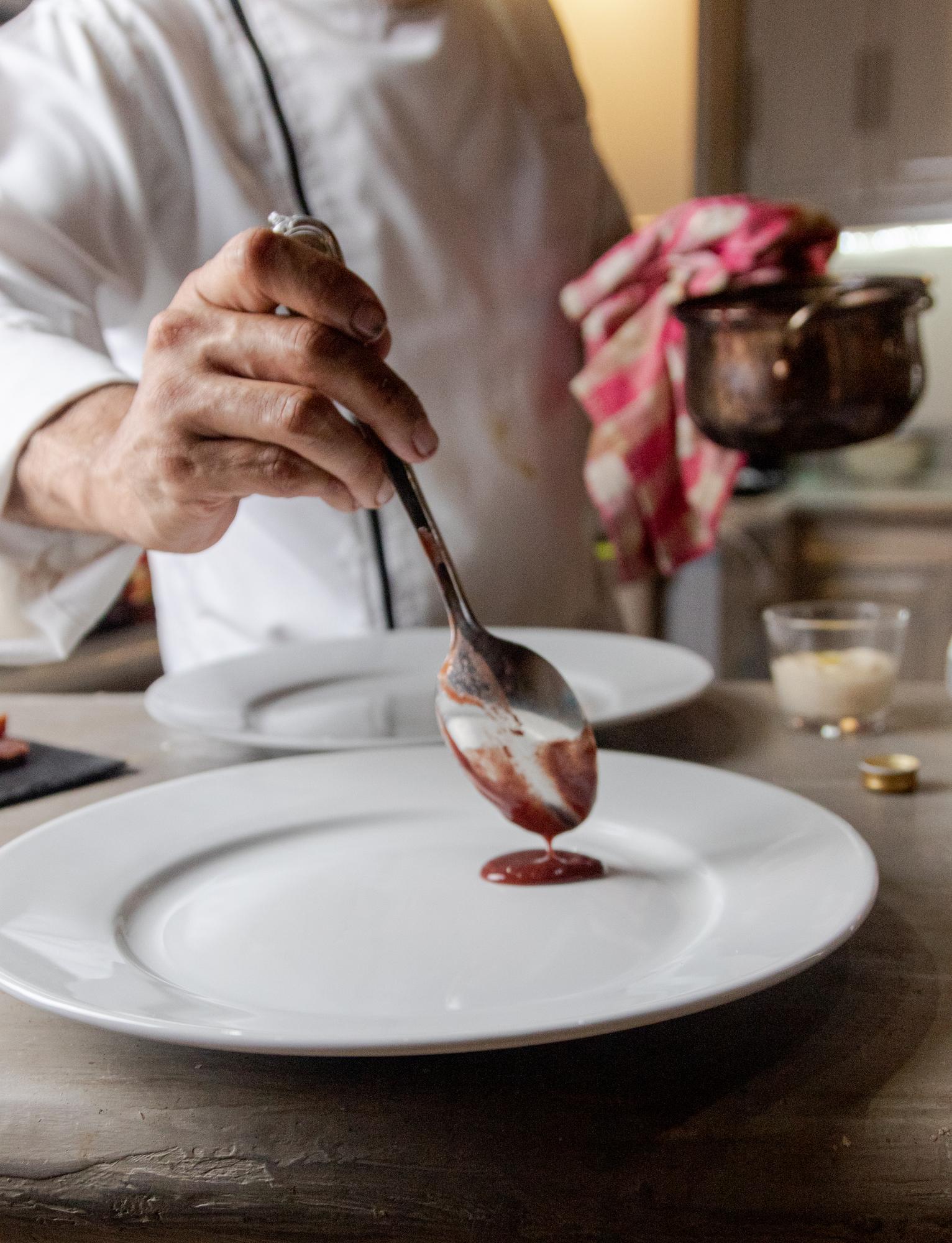 Hands plating dessert with tools